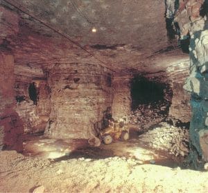 Photo of the Exxon Colony oil shale mine with dozer in front of large pillar