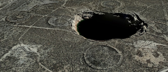 A sinkhole, approximately 300 yards in diameter and 30 yards deep, located in the Permian Basin of western Texas that formed from uncontrolled dissolution of a subsidence salt formation.